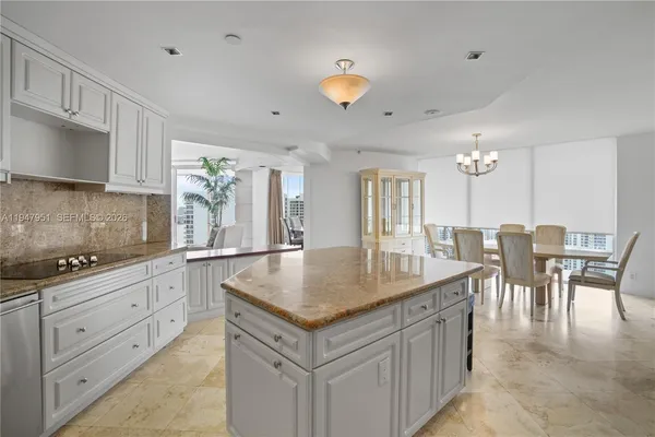a view of a dining room with furniture wooden floor and chandelier
