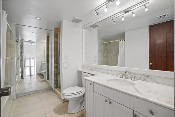 an empty room with closet and wooden floor