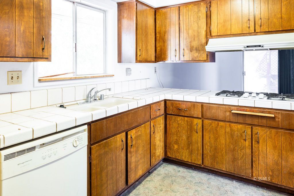 1243 Wayne Street Ridgecrest, CA 93555 - Photo 17 of 42 a kitchen with stainless steel appliances granite countertop a sink and a window