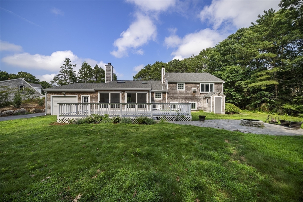 11 Hobbler Road Bourne, MA 02532 - Photo 8 of 41 a view of a house with a big yard potted plants and large tree