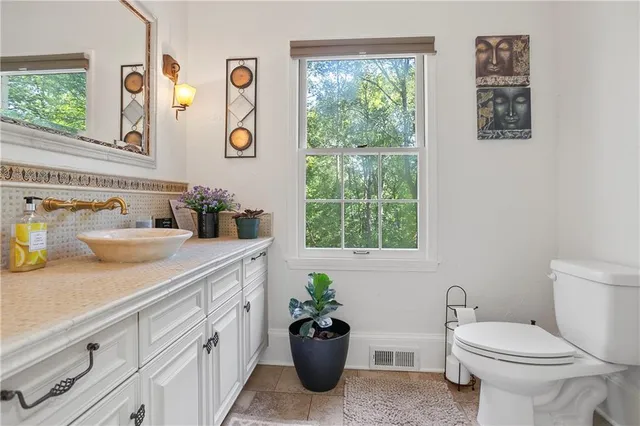 a bathroom with a sink a mirror and a toilet