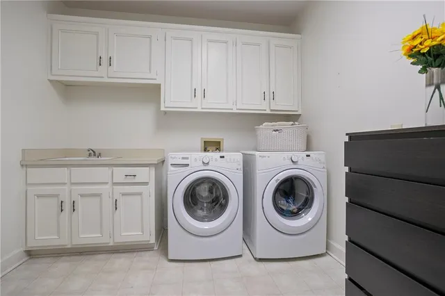 a utility room with sink dryer and washer