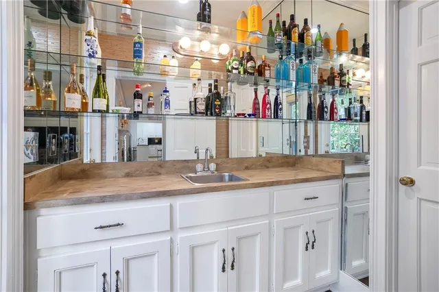 a bathroom with a granite countertop sink and a white cabinets