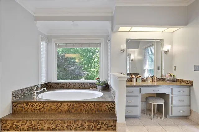 a bathroom with a bathtub sink vanity and mirror