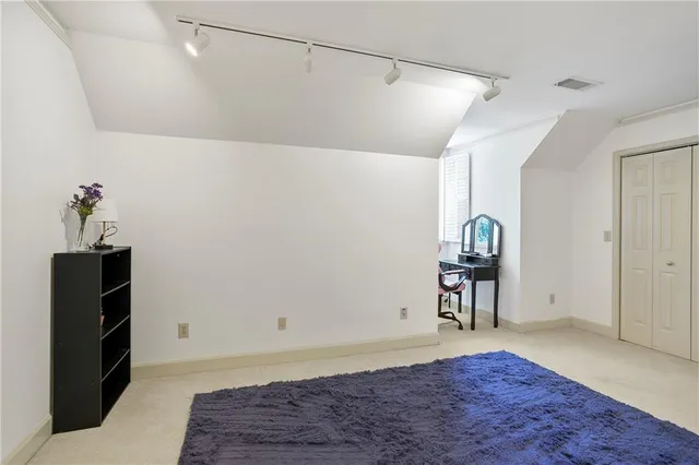 a view of a livingroom with wooden floor and a hallway