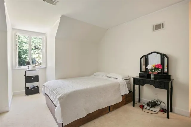 a bedroom with a bed and a table in it