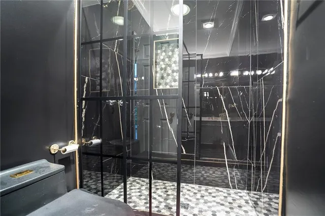 a living room with furniture a fireplace and a floor to ceiling window