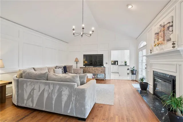 a living room with furniture a fireplace and a flat screen tv
