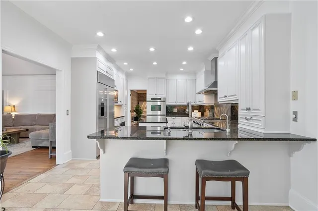 a kitchen with stainless steel appliances granite countertop counter top space a sink cabinets and refrigerator