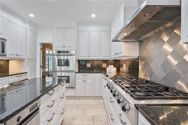 a kitchen with stainless steel appliances granite countertop a stove and a refrigerator