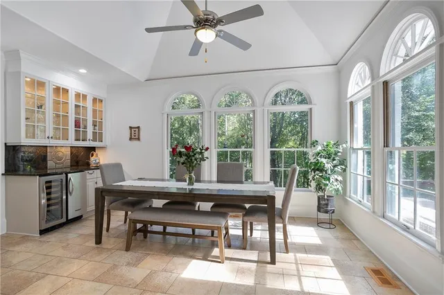 a dining room with furniture a chandelier and a rug