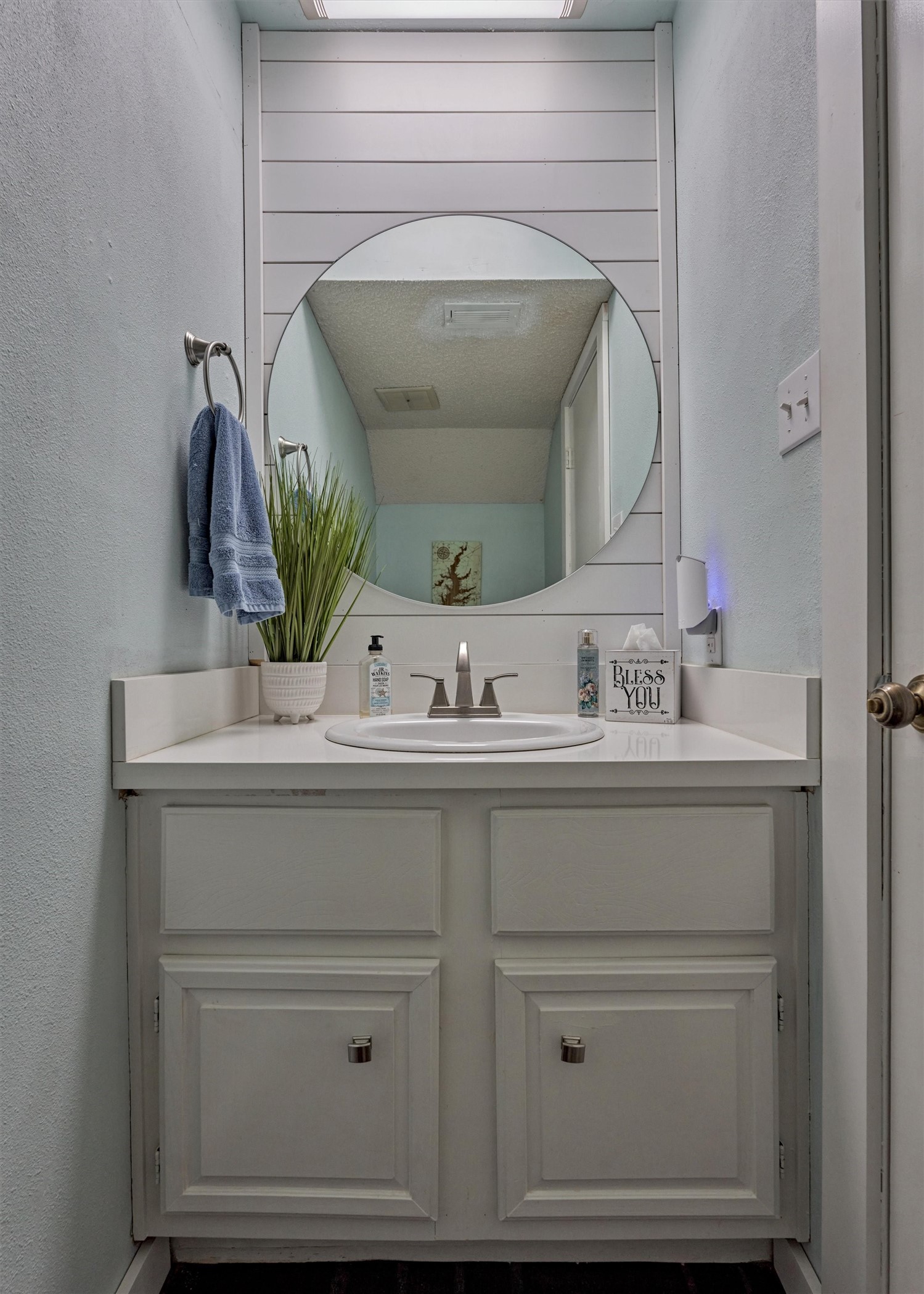 1428 Bowsprit Point Willis, TX 77318 - Photo 24 of 47 A half bath on the first floor also features the coastal inspired decor with the shiplap walls and round mirror.