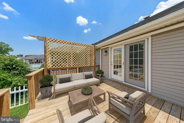 a roof deck with couches and potted plants