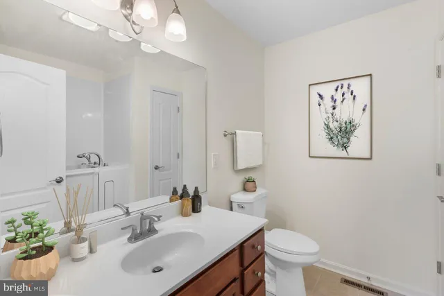 a bathroom with a sink toilet and a mirror