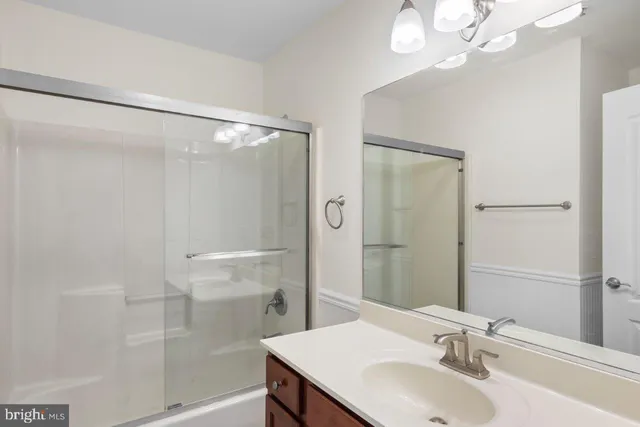 a bathroom with a sink a mirror and a shower