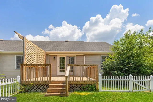 a front view of a house with a garden and plants