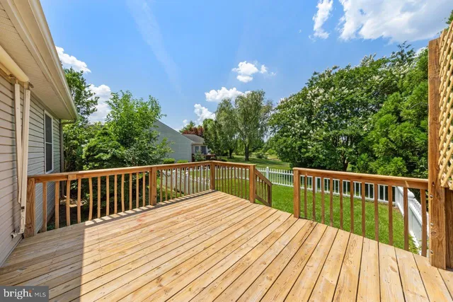 a view of balcony with wooden floor and fence