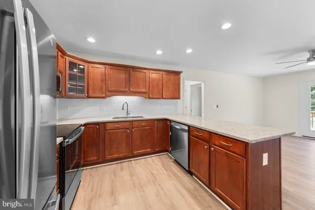 a kitchen with stainless steel appliances granite countertop a sink stove and cabinets