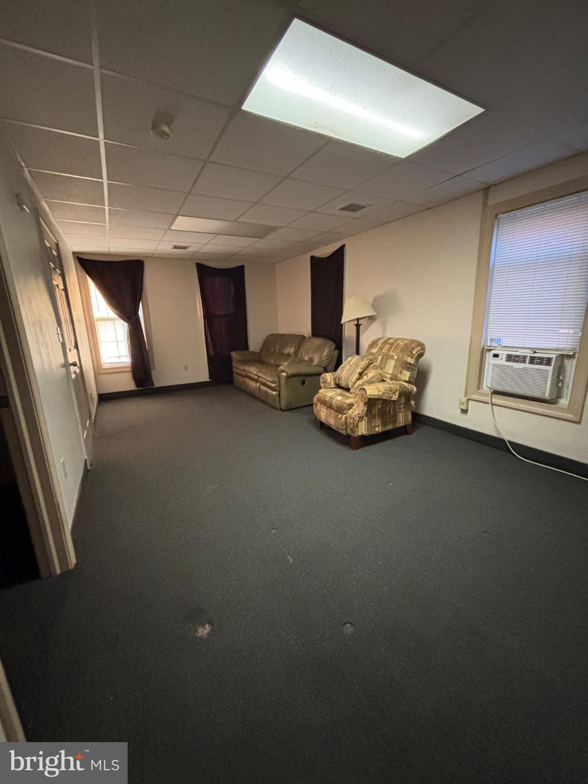 145 Main Street, Unit D Pennsburg, PA 18073 - Photo 2 of 8 a room with furniture and a chandelier