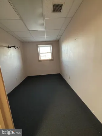 an empty room with a empty space and windows