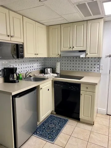 a kitchen with a sink stove top oven and cabinets