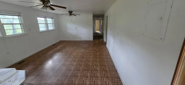 wooden floor in an empty room with a window