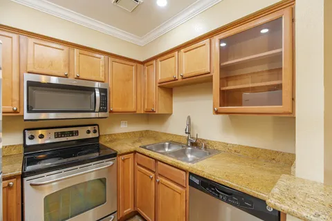 a kitchen with a sink and a stove top oven