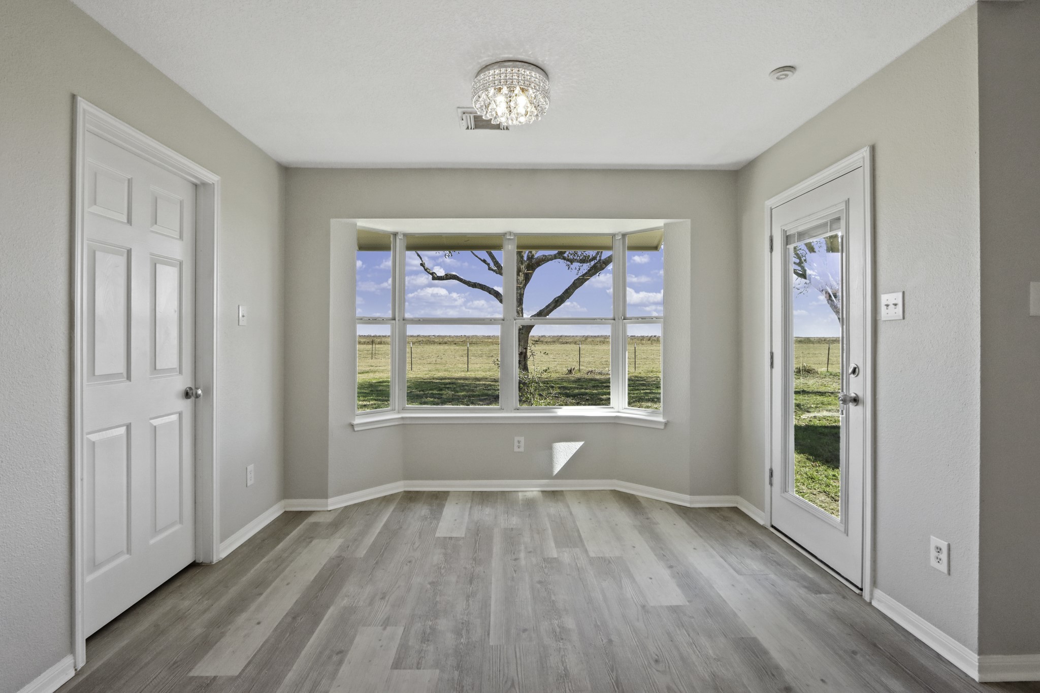 2445 Woods Road Brookshire, TX 77423 - Photo 10 of 29 wooden floor in an empty room with a window