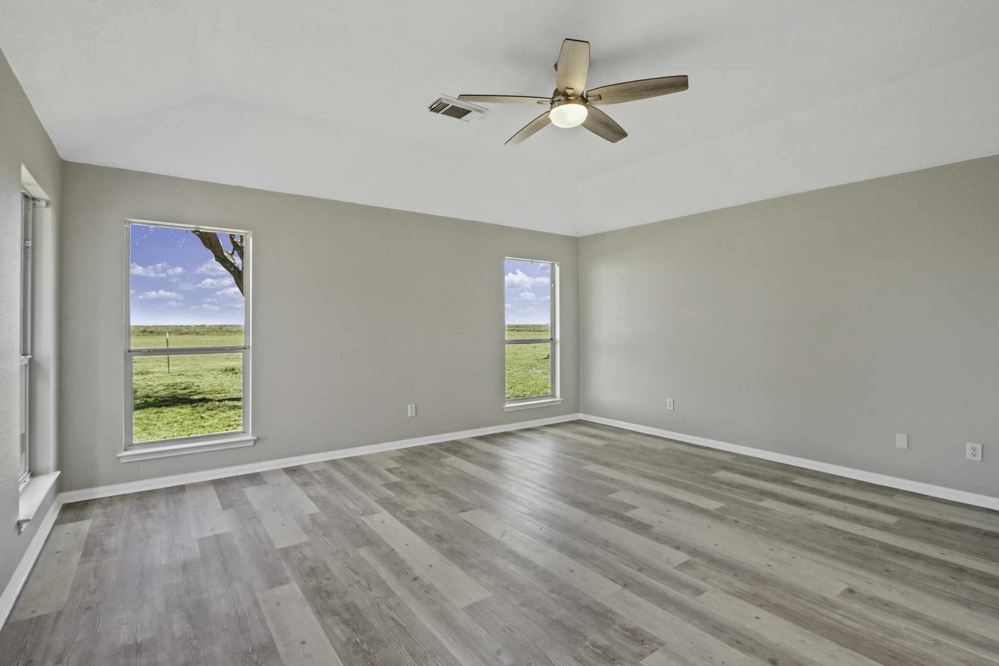 2445 Woods Road Brookshire, TX 77423 - Photo 12 of 29 wooden floor in an empty room with a window