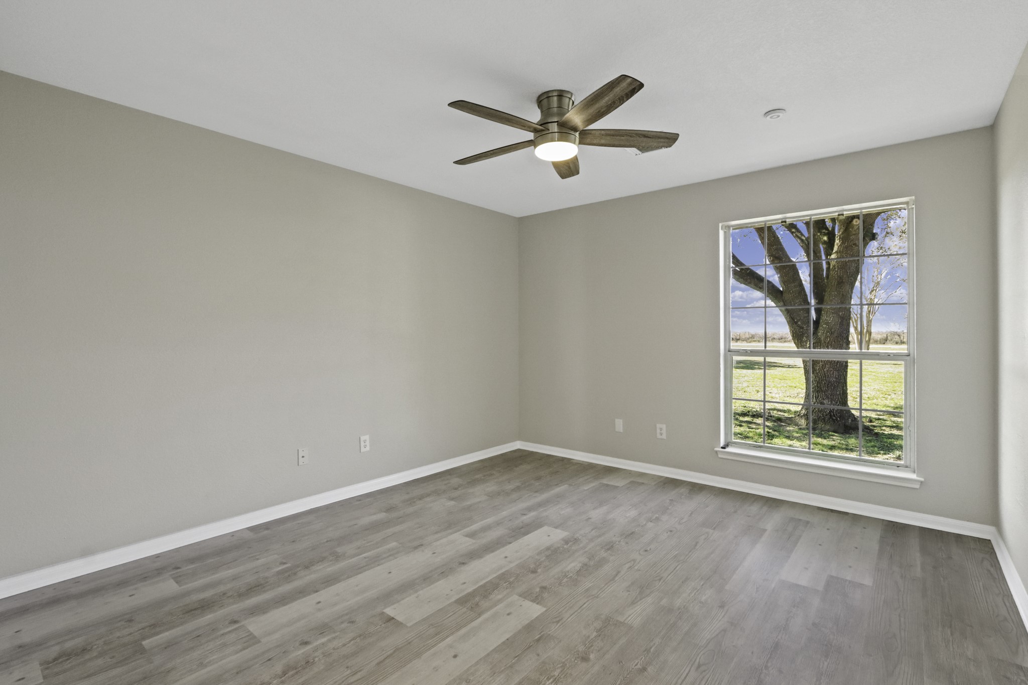 2445 Woods Road Brookshire, TX 77423 - Photo 18 of 29 wooden floor in an empty room with a window