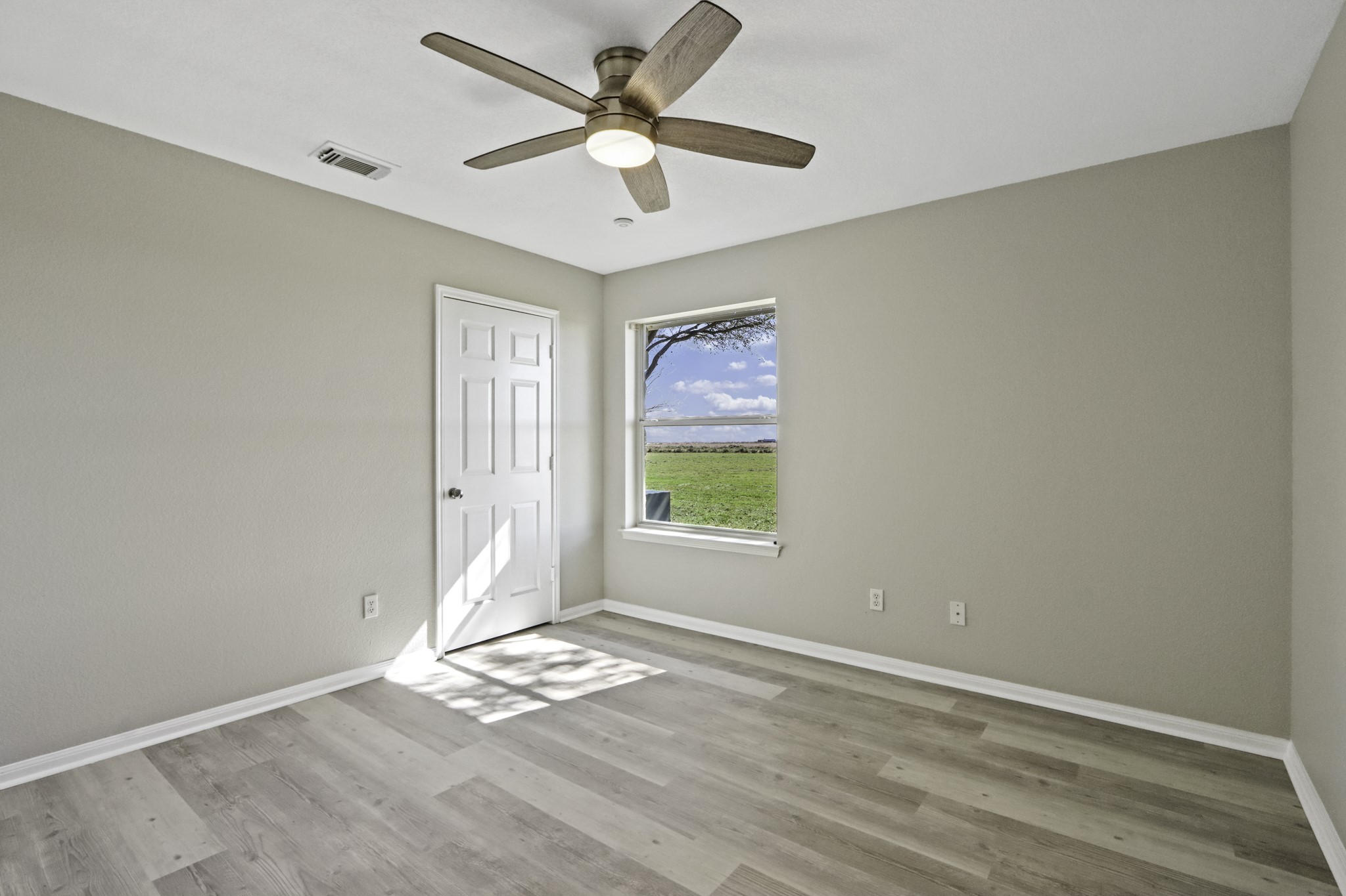 2445 Woods Road Brookshire, TX 77423 - Photo 19 of 29 an empty room with a window and a fan