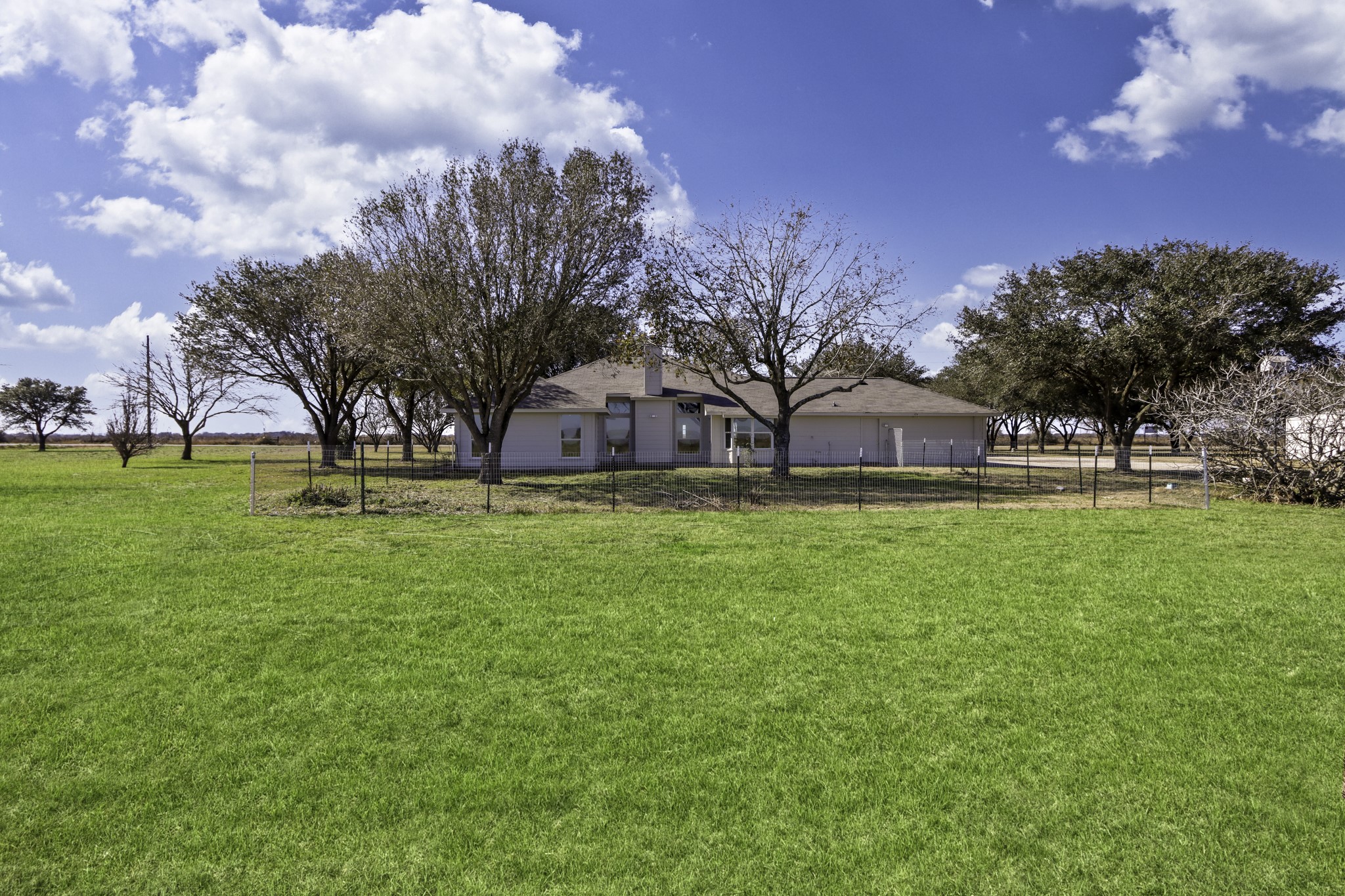 2445 Woods Road Brookshire, TX 77423 - Photo 23 of 29 a view of a big house with a big yard and large trees