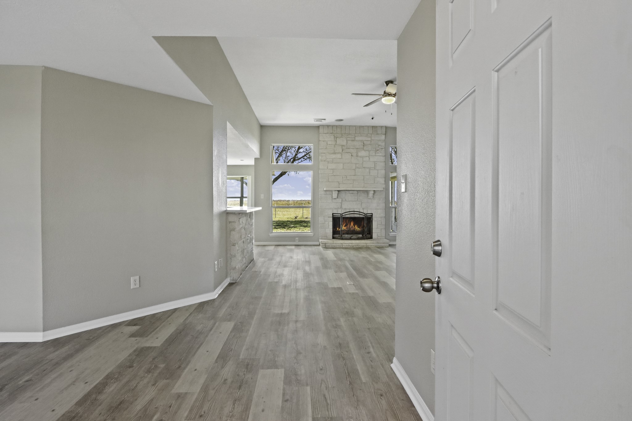 2445 Woods Road Brookshire, TX 77423 - Photo 3 of 29 a view of empty room with a fireplace and wooden floor