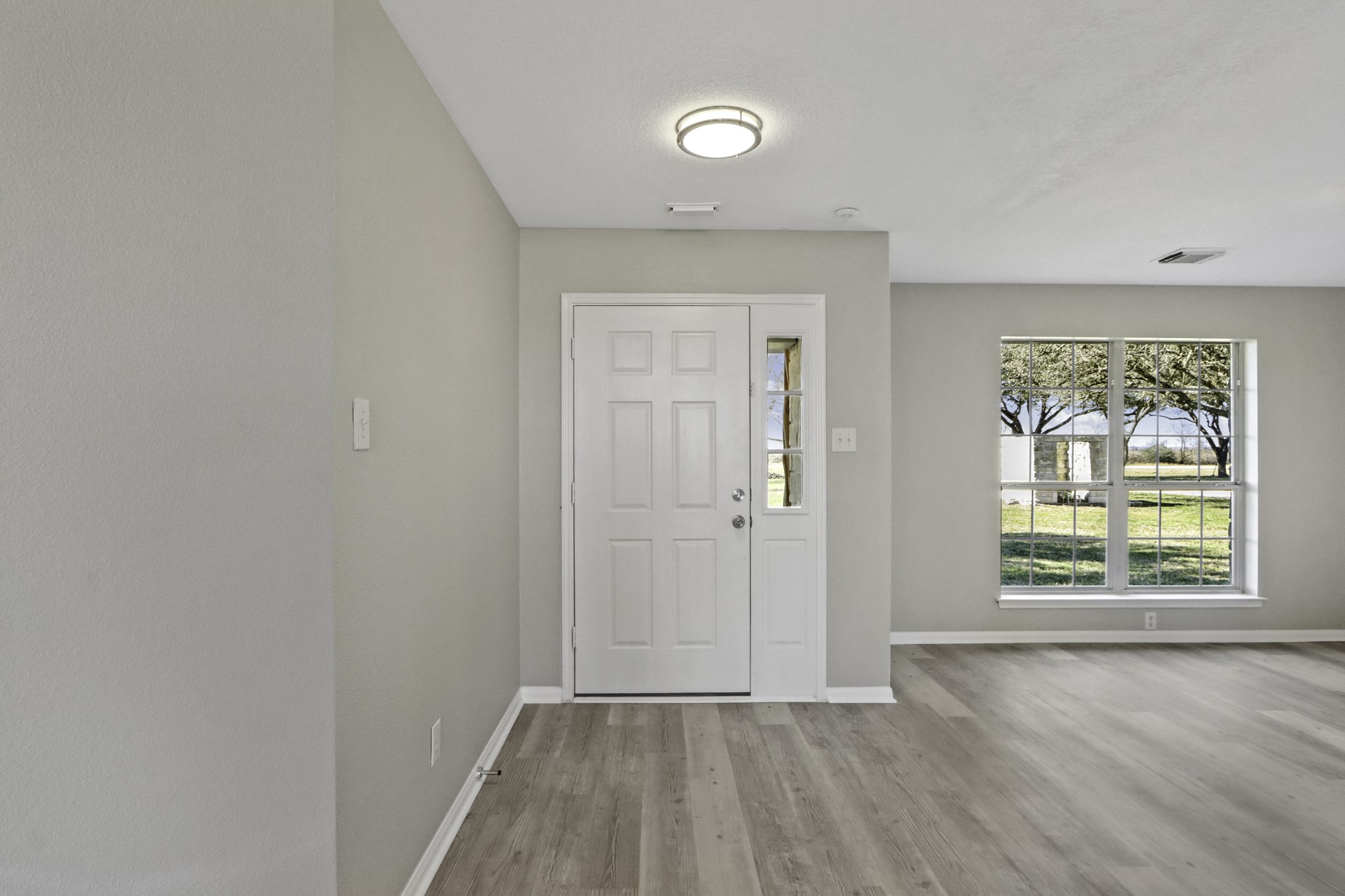 2445 Woods Road Brookshire, TX 77423 - Photo 4 of 29 an empty room with wooden floor and windows