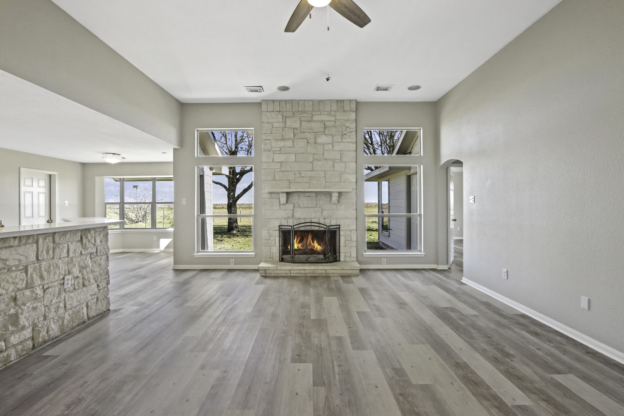 2445 Woods Road Brookshire, TX 77423 - Photo 7 of 29 a view of an empty room with wooden floor fireplace and a window