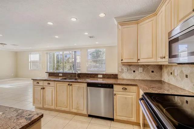 a kitchen with granite countertop white cabinets and white appliances