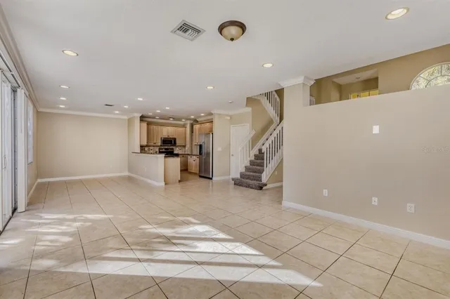 a view of a big room with entryway table and chairs