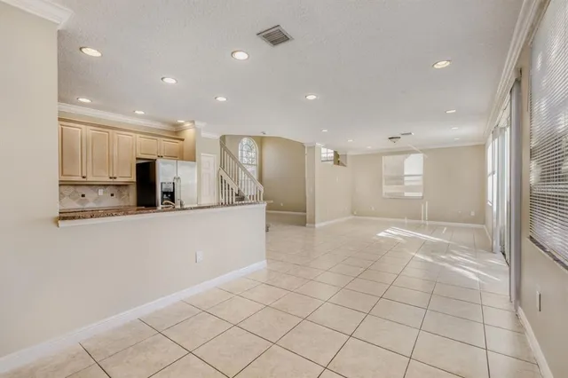a view of a kitchen with kitchen island granite countertop a refrigerator and a sink