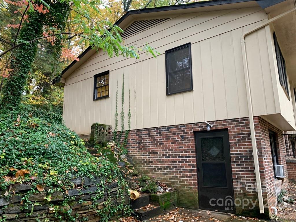 368 Hidden Hill Road Tryon, NC 28782 - Photo 11 of 19 a front view of a house with garden
