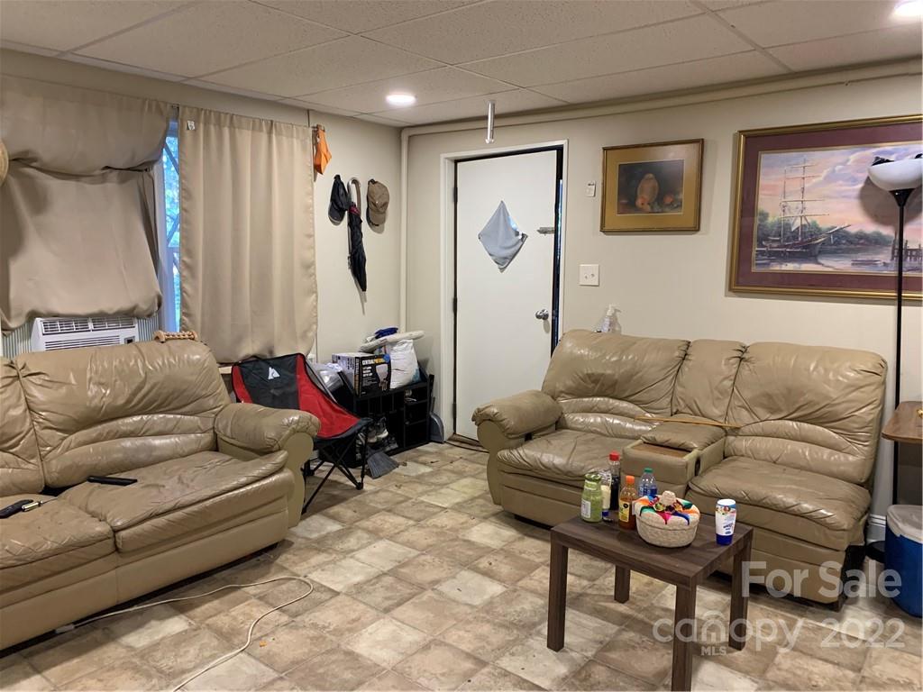 368 Hidden Hill Road Tryon, NC 28782 - Photo 12 of 19 a living room with furniture and a flat screen tv
