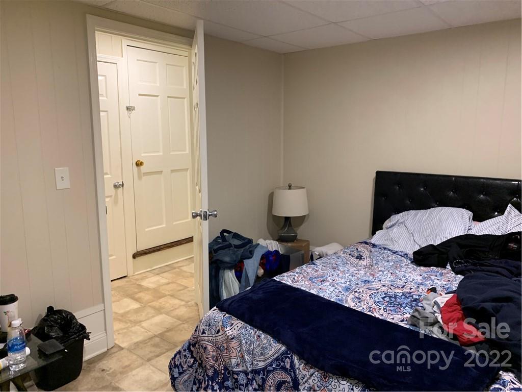 368 Hidden Hill Road Tryon, NC 28782 - Photo 16 of 19 a bedroom with a bed and a lamp on dresser