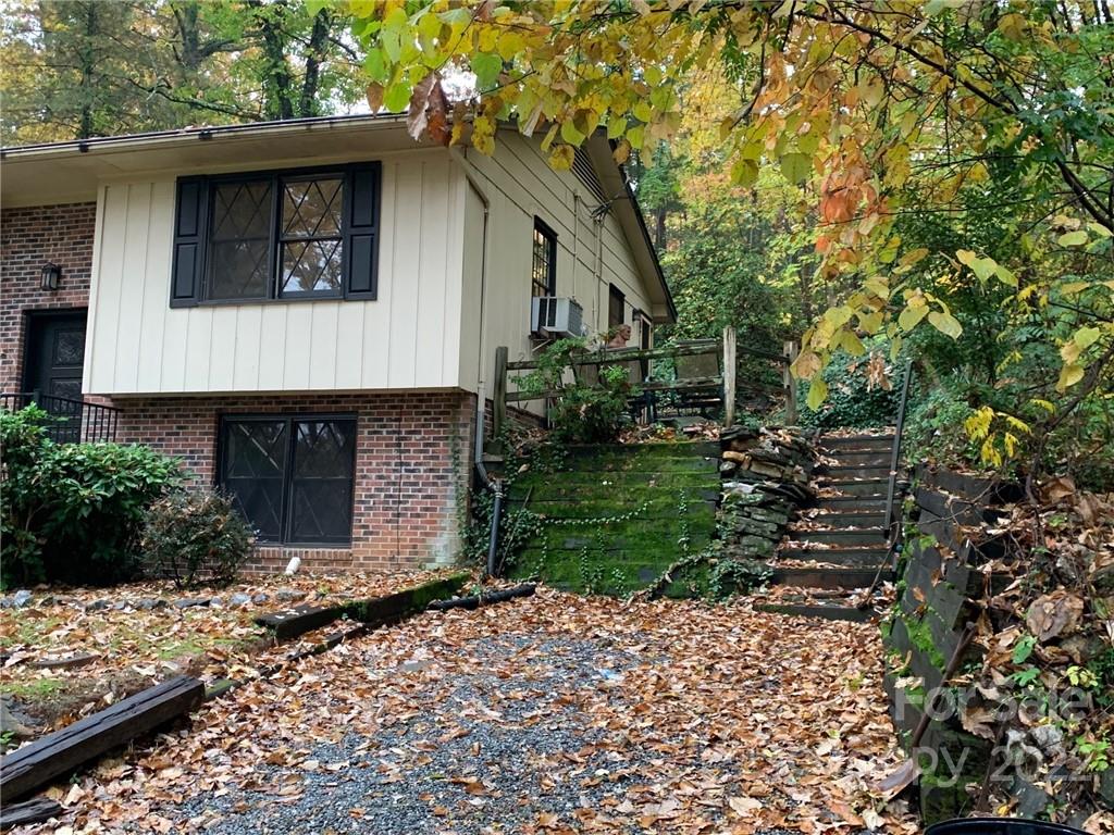 368 Hidden Hill Road Tryon, NC 28782 - Photo 2 of 19 a front view of a house with a yard