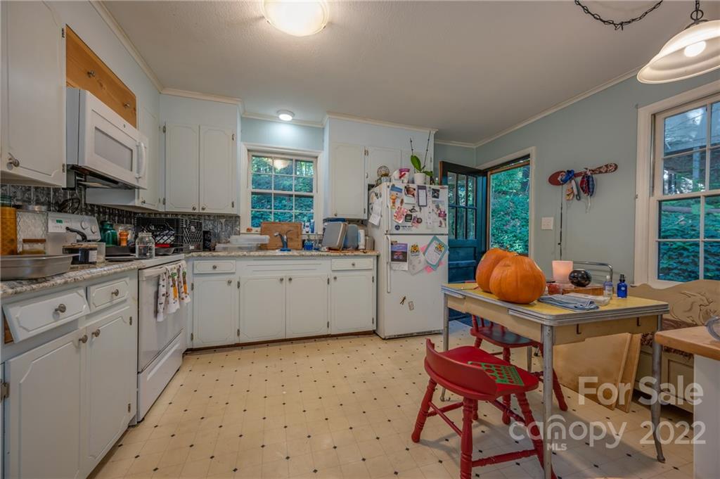 368 Hidden Hill Road Tryon, NC 28782 - Photo 3 of 19 a kitchen with stainless steel appliances kitchen island granite countertop a sink a stove a dining table and chairs