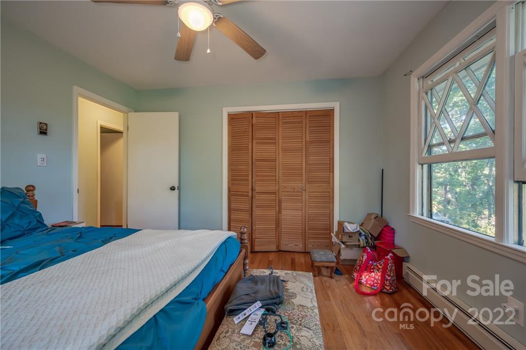 368 Hidden Hill Road Tryon, NC 28782 - Photo 9 of 19 a bedroom with a bed and a chandelier