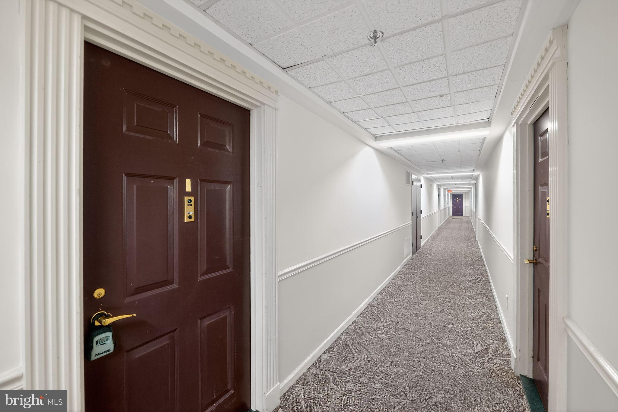 15107 Interlachen Drive, Unit 21022 Silver Spring, MD 20906 - Photo 2 of 33 a view of a hallway with wooden staircase