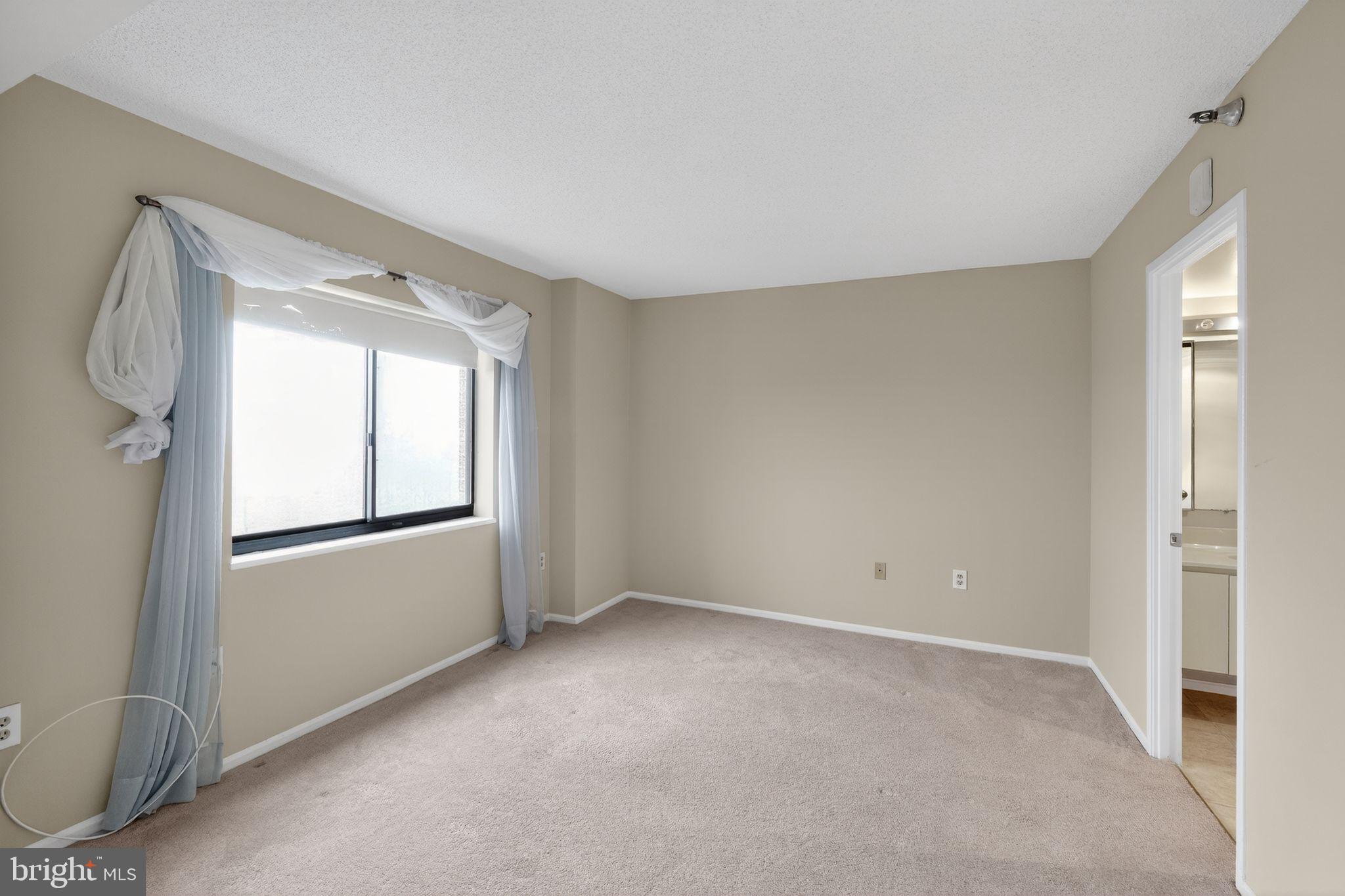 15107 Interlachen Drive, Unit 21022 Silver Spring, MD 20906 - Photo 22 of 33 a view of empty room with window