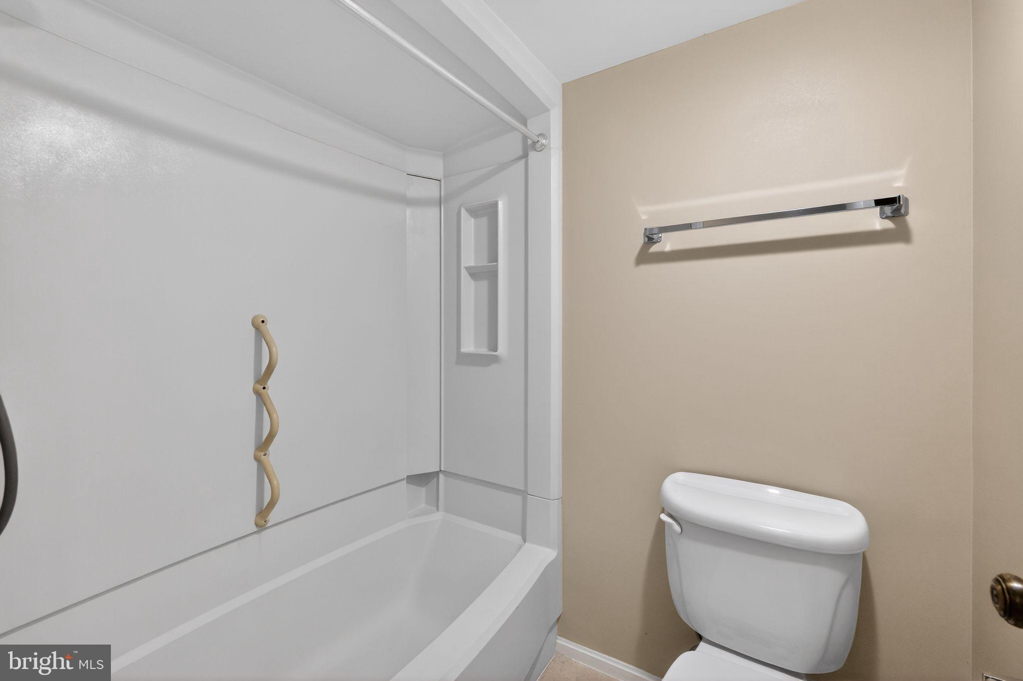 15107 Interlachen Drive, Unit 21022 Silver Spring, MD 20906 - Photo 23 of 33 a bathroom with a toilet and a bathtub