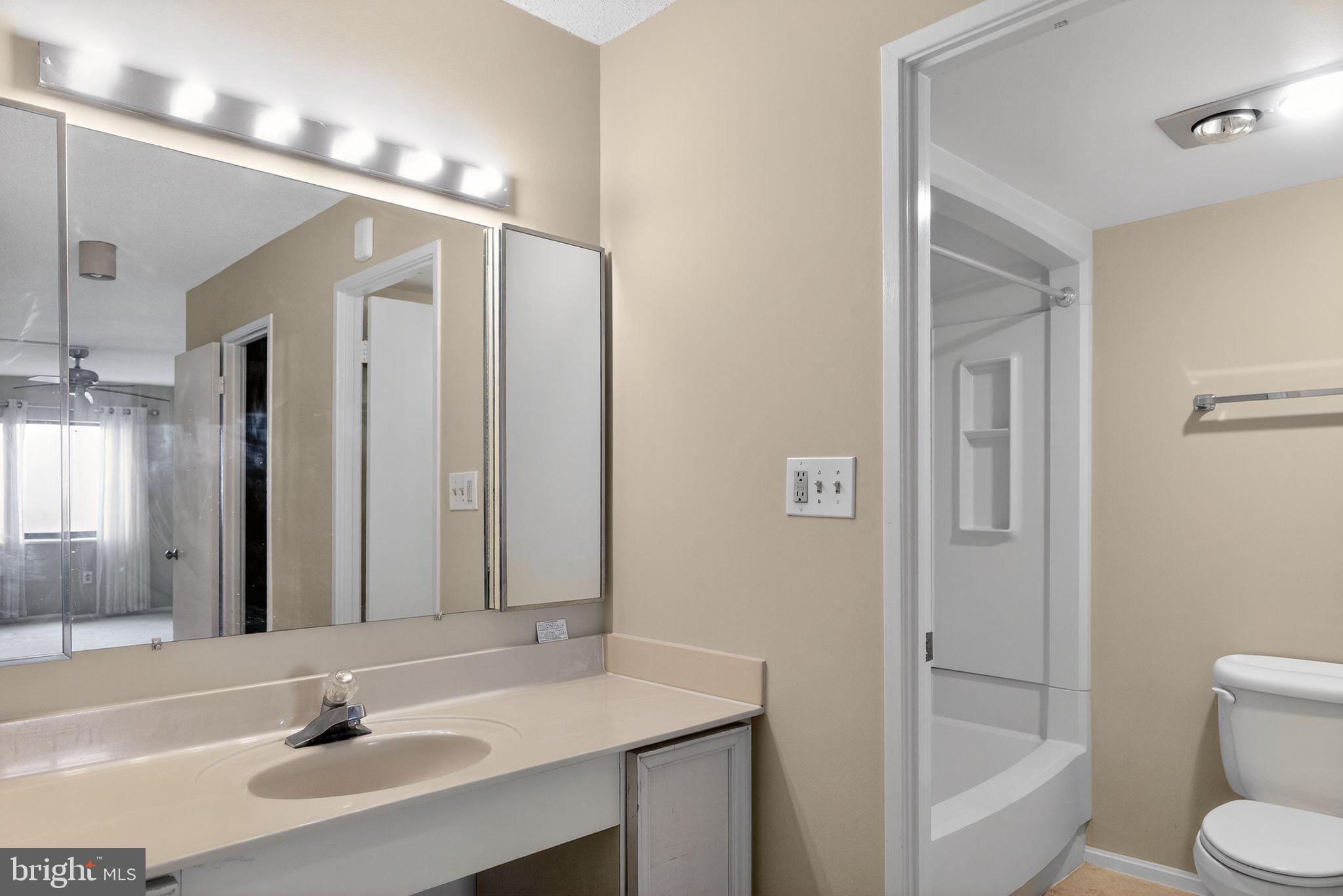 15107 Interlachen Drive, Unit 21022 Silver Spring, MD 20906 - Photo 27 of 33 a bathroom with a sink a toilet and shower