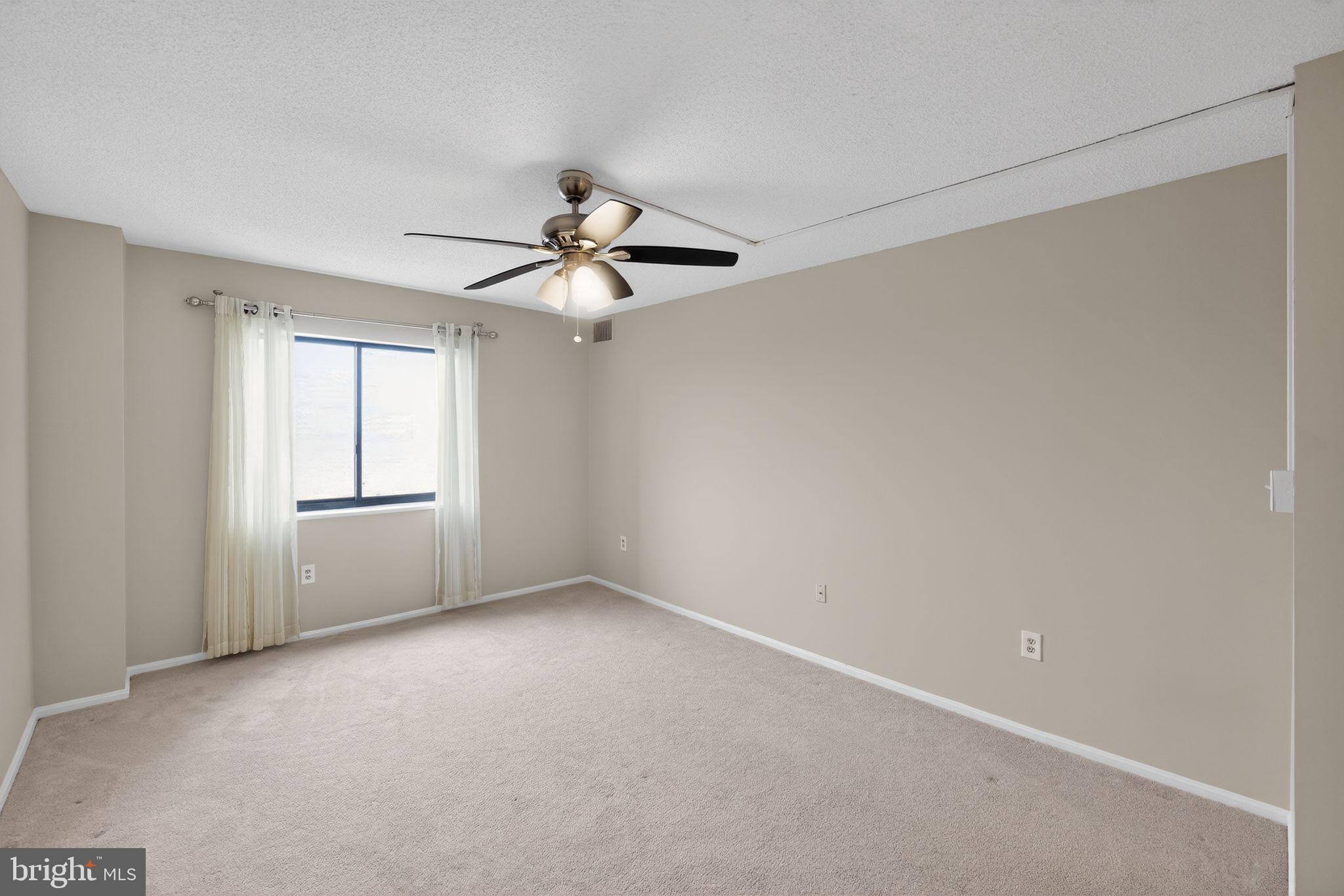 15107 Interlachen Drive, Unit 21022 Silver Spring, MD 20906 - Photo 5 of 33 a view of an empty room with a window