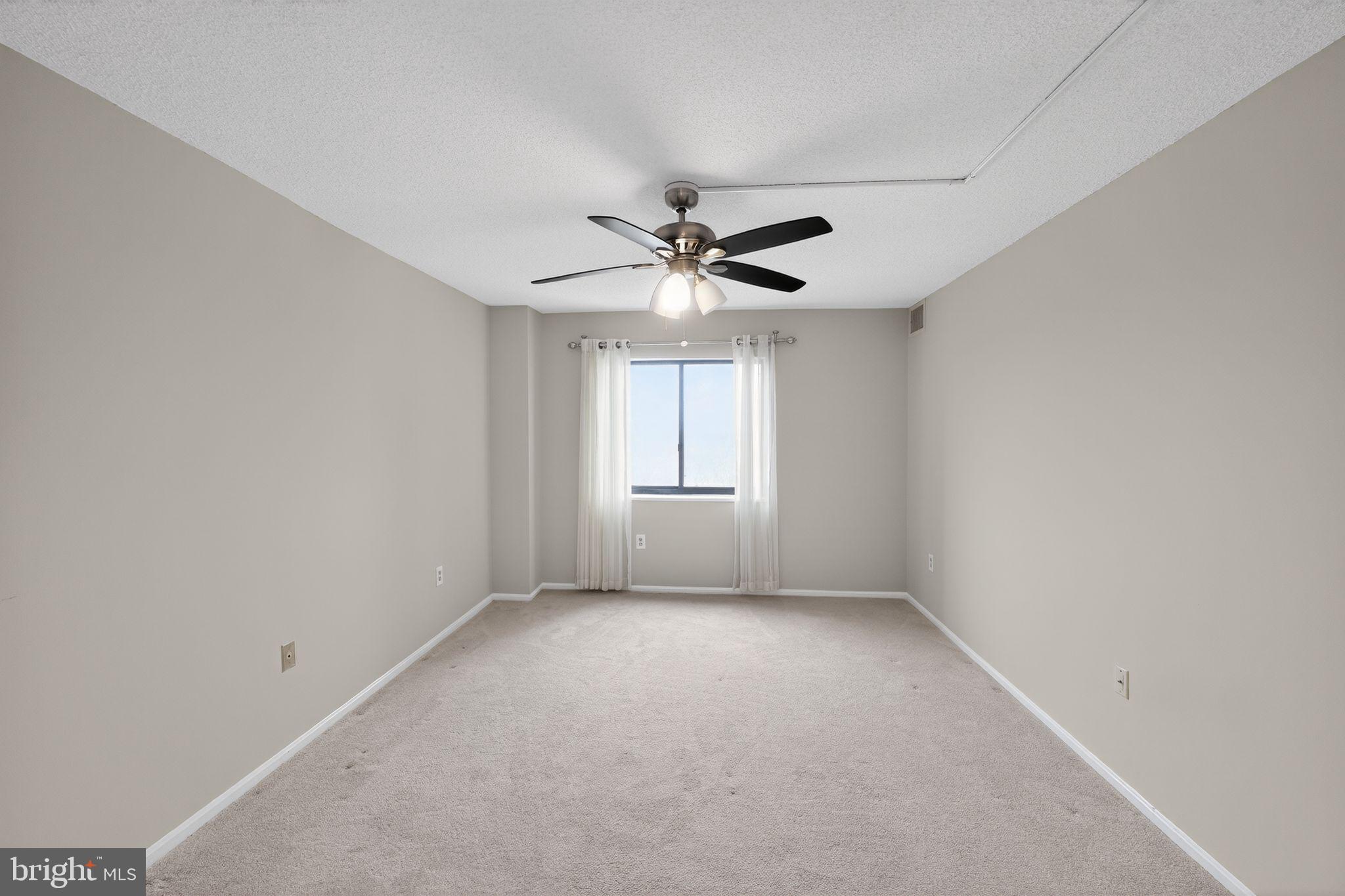 15107 Interlachen Drive, Unit 21022 Silver Spring, MD 20906 - Photo 6 of 33 a view of an empty room with a window